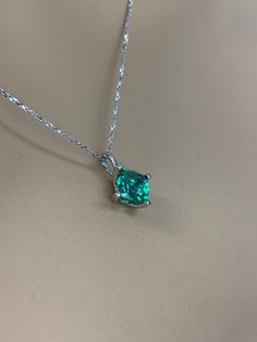 "This necklace is cushion cut lab created emerald ladies necklace, 18\" cable chain, 14k white gold #6160 Emerald is the birthstone of May -Stone Size: approx. 1.75 ct diamond equivalent -Stone Shape: Cushion cut 7x7mm -Gem Type: lab created emerald -Stone Clarity: VS2 -Stone Color: lively medium green, eye-clean -Moh's Scale: 8.5 hardness -Metal Type and Purity: 14k white gold -Setting: 4 prong open u -Country of Manufacturing: USA (Michigan) For customization please contact us. If you have any Emerald Necklace With Diamond Cut For May Birthstone, Emerald Diamond Cut Necklace For May Birthstone Gift, Silver Cushion Cut May Birthstone Jewelry, Cushion Cut May Birthstone Jewelry With Prong Setting, Green Necklace With Prong Setting, Cushion Cut Birthstone Jewelry For Gifts, Classic Green Birthstone Necklace For Anniversary, Cushion Cut Emerald Jewelry As A Gift, Cushion Cut Birthstone Jewelry Gift