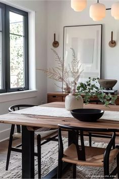 a dining room table with chairs and a bowl on it