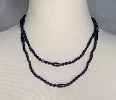 A vintage jet bead rope necklace from the 20's/30's. The antique necklace has faceted black round beads and oval tube beads. There is no clasp, the necklace fits over the head and can be doubled for a variety of looks. It measures 1/4" wide and 38" long.  Excellent condition. Catalog # 8802 Vintage Black Beaded Necklace With Beaded Chain, Adjustable Black Vintage Beaded Necklace, Bead Rope, Black Jet, Beaded Rope, Antique Necklace, Rope Necklace, Tube Beads, Strand Necklace