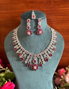 Charm and shine in this beautiful American diamond necklace set that features high quality AAA zircon necklace, earrings and maang tikka! It's sure to bring compliments your way with its unique design.  The necklace comes with an adjustable chain so that you can customise it as per the requirement of the outfit. Indian Bridal Jewelry, Necklace Set With Earrings, American Diamond Necklaces, Zircon Necklace, Maang Tikka, Diamond Necklace Set, Zircon Jewelry, Bridal Jewellery Indian, Flower Motif