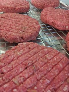 several hamburger patties cooling on a rack