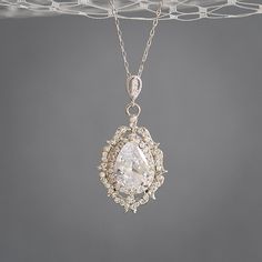 "Original Design by Glamorous Bijoux® This listing is for the LIBBY Necklace - This amazing pendant necklace features an unique vintage style filigree pendant with intricate details as the dramatic focal point, delicately embellished with pave rhinestones and cubic zirconia mounted in the setting to create an Old Hollywood glamour look. Carefully hung from a sterling silver or rose gold plated over sterling silver chain with an extender at the back. Measurements: Necklace length is approx. 16\" Exquisite Jewelry With Large Pendant For Wedding, Exquisite Wedding Jewelry With Large Pendant, Exquisite Large Pendant Jewelry For Wedding, Silver Oval Pendant Jewelry For Wedding, Elegant Large Pendant Necklace For Wedding, Elegant Wedding Necklace With Large Pendant, Elegant Vintage Charm Necklace For Anniversary, Vintage White Pear-shaped Jewelry, Classic Oval Pendant Necklace For Wedding