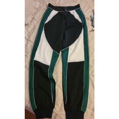 Size Small Womans Pants. Brand New. Tight At Waist And Hips, Loose On Legs, And Then Jogger Style At The Bottom. Has Stretch To It. Cute With A Crop Top And High Heels. Black, Green, And White. Zips Up The Middle. High Waist Sporty Joggers For Streetwear, Green Stretch Casual Joggers, Trendy High Waist Green Sweatpants, Trendy Green High Waist Sweatpants, Trendy High-waisted Green Sweatpants, Trendy Green Stretch Sweatpants, Sporty Fitted Pants For Streetwear, Trendy Green Sweatpants, Green Stretch Cotton Joggers