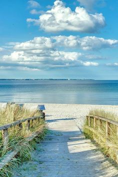 a wooden walkway leading to the beach