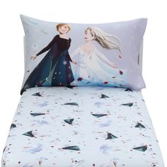 a bed with two pillows on top of it and an image of a frozen princess