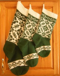 two green and white socks hanging on a door