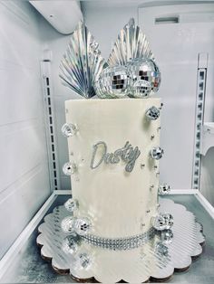 a white cake with silver decorations on top