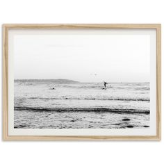 black and white photograph of surfers in the ocean