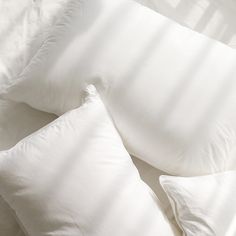 three pillows are laying on top of each other