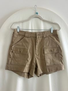 Taupe / Tan vintage cargo mini shorts by L.L. Bean, Sportif USA Lots of pockets! A few small spots on the front-- see photos. Good used condition. 62% Polyester, 34% Cotton, 4% Spandex Measurements: Waist: 30" Hips: 40" Rise: 10" Inseam: 5" Outseam: 14.5" Utility High Waist Shorts With Hip Pockets, Utility High-waisted Shorts With Hip Pockets, High-waist Utility Shorts With Hip Pockets, Utility High-waisted Cargo Shorts, Cargo Style Shorts For Outdoor, Short Length, High Waist Utility Cargo Shorts With Hip Pockets, Outdoor Cargo Style Shorts, Utility High-waisted Cargo Shorts With Patch Pockets, Utility Cargo Pants With Built-in Shorts