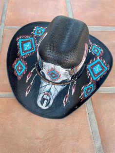 Hand painted vinyl cowboy hat with southwest-style and skull. Flexible fit. Includes rhinestones and glitter. One of a kind. Hand Painted Western Hat Bands For Festival, Hand Painted Adjustable Hat Bands For Rodeo, Hand Painted Adjustable Hat Band For Rodeo, Adjustable Hand Painted Hat Band For Rodeo, Hand Painted Adjustable Western Hat, Adjustable Hand Painted Western Hat, Southwestern Style Black Hat For Festivals, Black Southwestern Style Hat For Festival, Black Southwestern Style Festival Hat