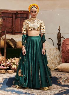 An exquisite creation, this lehenga in luxurious raw silk fabric is paired with a stylish zero neck matching blouse featuring three-fourth sleeves adorned with intricate mirror work. Complementing the outfit is a delicate organza dupatta (Optional: green or blue dupatta) that adds a touch of elegance and grace. Perfect for special occasions, this ensemble beautifully balances tradition and modern sophistication. Festive Organza Palazzo Set For Reception, Festive Silk Set With Unstitched Blouse, Tissue Silk Palazzo Set For Party And Festivals, Navratri Party Palazzo Set In Tissue Silk, Navratri Party Tissue Silk Palazzo Set, Party Tissue Silk Palazzo Set For Navratri, Festival Party Tissue Silk Palazzo Set, Green Chanderi Set For Reception, Green Lehenga With Cutdana And Kundan