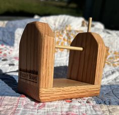 a small wooden chair sitting on top of a bed