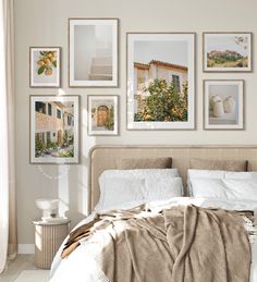 a bedroom with pictures on the wall above the bed