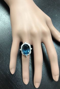 12.75 Carats Natural Impressive LONDON BLUE TOPAZ and Diamond 14K White Gold Ring Suggested Replacement Value $6,200.00 Total Natural London Blue Topaz Weight: Approx. 12.00 Carats London Blue Topaz Measures: Approx. 15 x 11mm Natural Round Diamonds Weight: .75 Carats (color G-H / Clarity SI1-SI2) Ring total weight: 9.0 grams Disclaimer: all weights, measurements and colors are approximate and may vary slightly from the listed dimensions or as seen in the image. All pictures are magnified to sho Luxury Platinum Topaz Gemstone Ring, Luxury Oval Topaz Ring, Luxury Topaz Ring With Diamond Accents, Luxury Platinum Gemstones With Accent Stones, Formal Blue Topaz Platinum Ring, Luxury Platinum Topaz Ring With Halo Setting, Luxury White Gold Topaz Ring, Luxury Topaz Ring With Brilliant Cut For Formal Occasions, Luxury Platinum Topaz Ring With Accent Stones