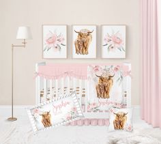 a baby crib bedding set with pink flowers and an image of a cow