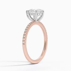 a rose gold engagement ring with diamonds on the side