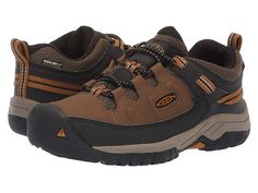 KEEN Kids Targhee Low WP (Little Kid/Big Kid) - Boy's Shoes : Dark Earth/Golden Brown : Hike from mountain-to-mountain with savvy gear by sporting the durable Keen Kids Targhee Low WP Hiking shoe. Sturdy hiking shoe is constructed in a waterproof leather upper with KEEN.Dry finish and breathable mesh underlays featuring Cleansport NXT technology to naturally control unwanted odors. Robust sneaker is constructed with a protective toe bumper, bungee laces with a toggle closure, and an adjustable a Brown Gore-tex Sporty Walking Shoes, Sporty Brown Gore-tex Walking Shoes, Brown Fade-resistant Sneakers For Walking, Brown Fade-resistant Walking Sneakers, Fade-resistant Brown Sneakers For Walking, Sports Sneakers With Reinforced Toe And Leather, Sports Sneakers With Reinforced Toe And Leather Material, Leather Sneakers With Reinforced Toe For Sports, Sporty Brown Gore-tex Sneakers