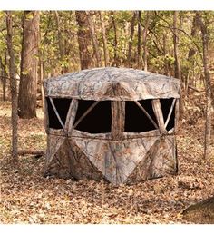 a hunting blind in the woods surrounded by trees