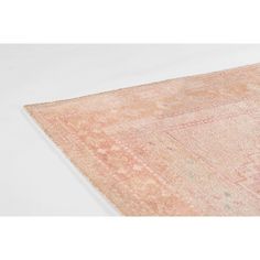 an orange and pink rug on a white surface with no one in the room to see it