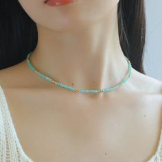 Crafted with exquisite Amazonite gemstones and delicately intertwined with shimmering gold beans, this necklace exudes elegance and sophistication. Elevate your look with its subtle yet striking beauty, perfect for any occasion. Whether worn alone or layered with other pieces, this necklace is sure to make a statement wherever you go. Metal: 18K Recycled Gold Plated On Brass Gemstone: Amazonite(2-2.5mm/3-3.5mm) Length: 410-450mm Weight: 4-6g Elegant Emerald Necklace With Beaded Chain, Delicate Gemstone Beaded Necklaces, Delicate Gold Beaded Crystal Necklaces, Delicate Gold Beaded Crystal Necklace, Adjustable Beaded Emerald Necklace In Elegant Style, Turquoise Round Beads Emerald Necklace, Delicate Gemstone Beads For Jewelry Making, Gold Beaded Minimalist Crystal Necklace, Dainty Beaded Necklaces With Gold Beads