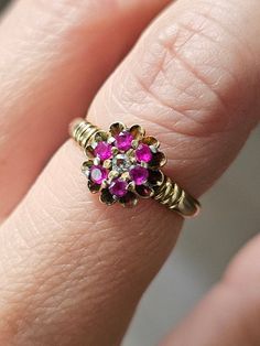 Ruby & Diamond 14K Ring Vintage Women Ruby Flower Ring Size 5.5 Vintage 14K ruby & diamond flower design ring in a very pretty wedding cake setting.  In great, ready to love condition.  Not marked but tests as 14k. Diamond & rubies are natural, mined gemstones.  Currently a size 5.5. Formal Pink Flower-shaped Rings, Yellow Gold Flower Ring With 17 Jewels For Anniversary, Anniversary Red Cluster Ring Stamped 14k, Vintage Yellow Gold Flower Ring With Gemstone, Yellow Gold Flower Ring With Center Stone For Anniversary, Anniversary Flower Ring In Yellow Gold With Center Stone, Anniversary Yellow Gold Flower Ring With Center Stone, Antique Brilliant Cut Ruby Ring For Wedding, Ruby Cluster Ring With Rose Cut Diamonds