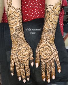 two hands with henna tattoos on them