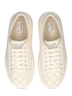 52mm Heel. Off-white canvas with GG embroidered upper. Off-white trim. Front lace-up closure. Logo details. Gucci Tennis 1977 label . All over pattern placement may vary. Rubber platform sole. Includes additional pair of laces All Over Pattern, Ski Accessories, Mule Sandals, Flat Espadrilles, Swim Accessories, Heeled Loafers, Shearling Jacket, White Trim, Ski Wear