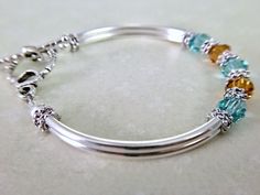 Gift the bracelet for any occasion including birthday, anniversary, bridesmaids gifts, anniversary or just because... Message me to change the crystal colors or even create a mothers bracelet. ~ 6mm lt turquoise and topaz swarovski crystals ~ antiqued silver pewter spacers ~ silver plated tube bead bangles and lobster claw Click here to return to my shop's homepage: https://www.etsy.com/shop/beadedjewelryforyou?ref=simple-shop-header-name&listing_id=604235185 Adjustable Jewelry For Mom's May Birthstone Gift, Sterling Silver Birthstone Bracelets For Wedding, Adjustable Silver Crystal Bracelet With Birthstone, Silver Beaded Bracelets With Birthstone For Wedding, Adjustable Silver Birthstone Crystal Bracelet, Adjustable Birthstone Beaded Bracelets For Anniversary, Adjustable Birthstone Bracelets As Gift For Mom, Adjustable Turquoise Jewelry For May Birthstone, Silver Birthstone Bangle Jewelry