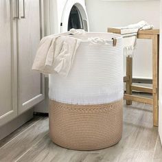 a laundry basket sitting on the floor in front of a washer and dryer