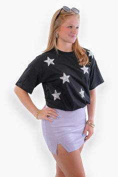 Get ready to shine like a star in our  Black & Silver Sequin Star Tee ! This trendy and fun t-shirt is perfect for gameday or a country concert, featuring all-over silver sequin stars on a black background, creating a bold and eye-catching design. The tee is soft and comfy to wear, ensuring you stay stylish and comfortable throughout the day.   Features:   Trendy black t-shirt with all-over silver sequin stars.  Eye-catching design perfect for gameday or a country concert.  Soft and comfortable fabric for all-day wear.  Versatile style pairs well with denim shorts, jeans, or skirts.  High-quality construction for long-lasting wear. Shine Like A Star, Country Concert, Country Concerts, Shorts Jeans, Silver Sequin, Star Shirt, Versatile Style, Black T Shirt, Black Background