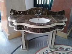 a marble sink and mirror in a room