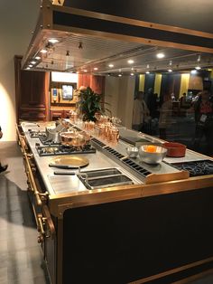 a large kitchen with lots of counter space and gold trimmings on the counters