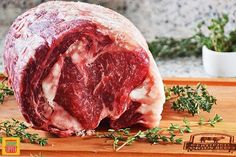 raw meat sitting on top of a wooden cutting board