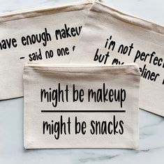 three makeup bags with words written on them