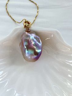 Enhance your jewelry collection with this stunning baroque pearl pendant featuring a purple and blue baroque pearl. Handpicked high quality and iridescent freshwater pearl with excellent luster that captures light beautifully, this AAA quality pearl pendant with metallic reflection is perfect for adding a touch of refinement to any outfit or bringing a sense of elegance to your everyday accessories. Baroque pearls all come in unique shapes, making each piece one-of-a-kind. Impress your loved one Baroque Pearl Jewelry With Pearl Charm For Party, Iridescent Pearl Drop Jewelry For Wedding, Elegant Iridescent Jewelry With High Luster, Elegant Iridescent High Luster Jewelry, Elegant Iridescent High-luster Jewelry, Baroque Pearl Jewelry With Round Pearl Charm Pendant, Party Pearl Necklace With Baroque Pearl Charm, Party Pearl Necklace With Baroque Pearl Pendant, Baroque Pearl Chain Round Pendant Jewelry