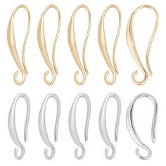 six pairs of gold and silver metal hooks, each with long curved tails on the ends