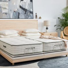 two mattresses sitting next to each other on a bed in a room with a rug