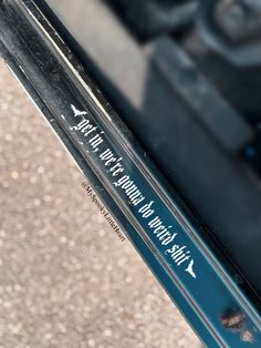 a close up view of the side of a car door handle with writing on it