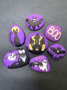 painted rocks with bats and ghost faces on them for someone's 80th birthday