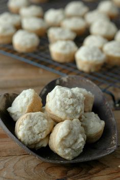 a wooden spoon filled with sugar cookies on top of a table next to cooling rack