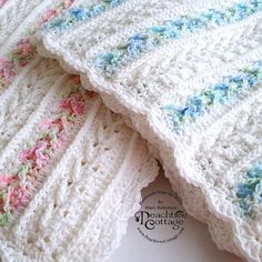 two crocheted blankets laying on top of each other