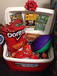 a cooler filled with snacks and condiments on top of a carpeted floor