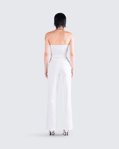 Nothing beats a monochromatic fit 🤍 Featuring an ivory symmetrical top, paired with low rise tie pants - this ensemble exudes effortless chicness in a way that will impress them all 🤩 White Sleeveless Pantsuit For Night Out, Elegant Stretch White Pantsuit, Elegant White Stretch Pantsuit, Sleek White Top For Spring, Chic Fitted Summer Pantsuit, Elegant White Cropped Bottoms, Chic White Pantsuit For Party, White Evening Bottoms For Summer, White Summer Evening Bottoms