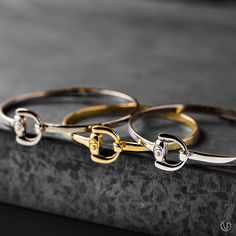 Equestrian Bangles with a horse bit design in Sterling Silver, Rose Gold, and Rhodium.  -Vincent Peach   #vincentpeach #marathonvillage #madeintn #madeinnashville #luxuryjewelry #designerjewelry #highfashionjewelry #bangle #bracelet #rosegold #sterlingsilver #rhodium #equestrianjewelry #equestrianluxury #equestrianbracelet #affordableluxury #rosegoldbracelet #rhodiumbracelet #sterlingsilverbracelet #gift #giftidea #giftguide #giftbracelet  #jewelrylover Luxury Gold Sterling Silver Bangle, Equestrian Bracelet Jamies Horse Jewelry, Luxury Elegant Jewelry With Horse Design, Equestrian Jewelry Ashley's Equestrian Jewelry, Luxury Unique Leather Jewelry, Luxury Sterling Silver Bangle Bracelets, Luxury Artisan Bracelets As Gift, Luxury One-of-a-kind Bangle Jewelry, Luxury Sterling Silver Bangle As Gift