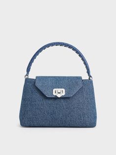 This product is made with at least 20% sustainable materials by weight. CHARLES & KEITH uses recycled, degradable, organic, and water-based materials in our eco-conscious collection. This iteration of the Arwen bag proves that denim really is for every occasion. Details like a braided top-handle and denim finish relaxes the top-handle style, imbuing it with a cool-girl appeal that can be adapted for casual and formal occasions alike. With the addition of a push-lock closure that doubles as a metallic accent, the bag exudes effortless charm -- carry it by hand for an elevated look, or convert it into a crossbody bag to dress it down. Latest Bags, Brand Collaboration, Charles Keith, Braided Strap, Strap Tops, Eco Conscious, Sustainable Materials, Handle Bag, Metallic Accents