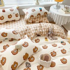 a bed with teddy bears on it in a room next to a table and window