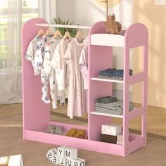 there is a pink shelf with clothes on it