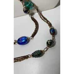 This is part of Chairish’s Costume Jewelry assortment.  Unique and rare vintage 57” lariat made of iridescent Murano glass interspersed with chain. This necklace is so versatile in that it can be wrapped up to 3x’s and of course tied lariat style. The glass is mainly in blues, greens, and purples of different shapes sizes and texture. A real stunner. Party Lariat Necklaces With Beaded Chain, Elegant Blue Chain Necklace For Party, Double Strand Beaded Chain Jewelry For Party, Costume Jewelry Glass Party Jewelry, Elegant Glass Jewelry For Party, Formal Double Strand Beaded Chain Necklaces, Formal Double Strand Beaded Chain Necklace, Formal Long Necklace With Adjustable Chain, Elegant Blue Long Chain Necklace