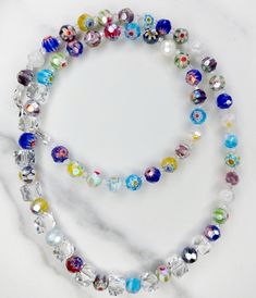 Colorful Milliefiori glass beaded necklace Colorful Glass Beads Jewelry For Party, Multicolor Glass Necklaces With Faceted Beads, Colorful Beaded Glass Jewelry For Party, White Glass Jewelry With Large Beads, Party Jewelry With Colorful Glass Beads, Elegant Round Glass Crystal Necklaces, Czech Glass Jewelry With Large Round Beads, Multicolor Crystal Jewelry With Spacer Beads, Glass Large Beads Long Necklace